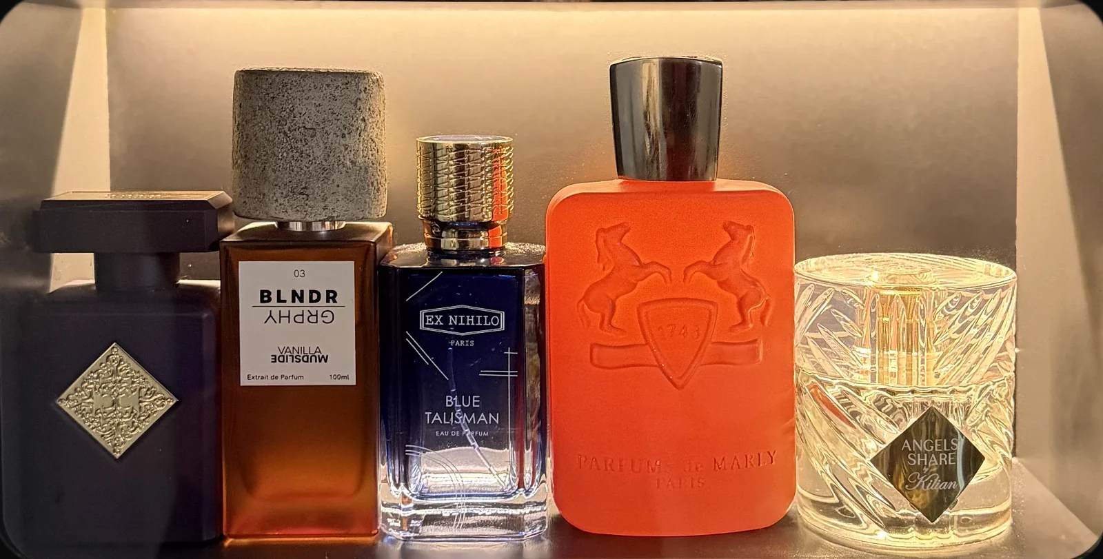Fragrance bottles lit behind the unit's glass window